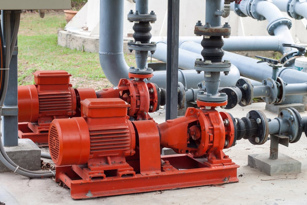 A Red Motor Water Pump And Water Pipes