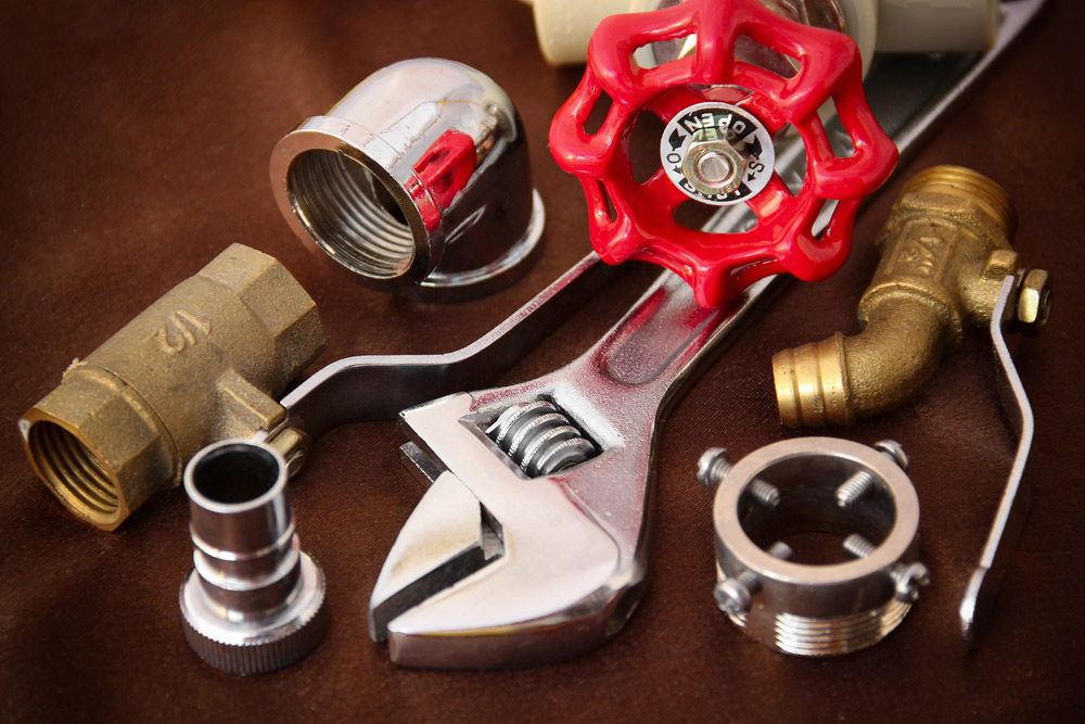 Plumbing Supplies on Top of A Wooden Table